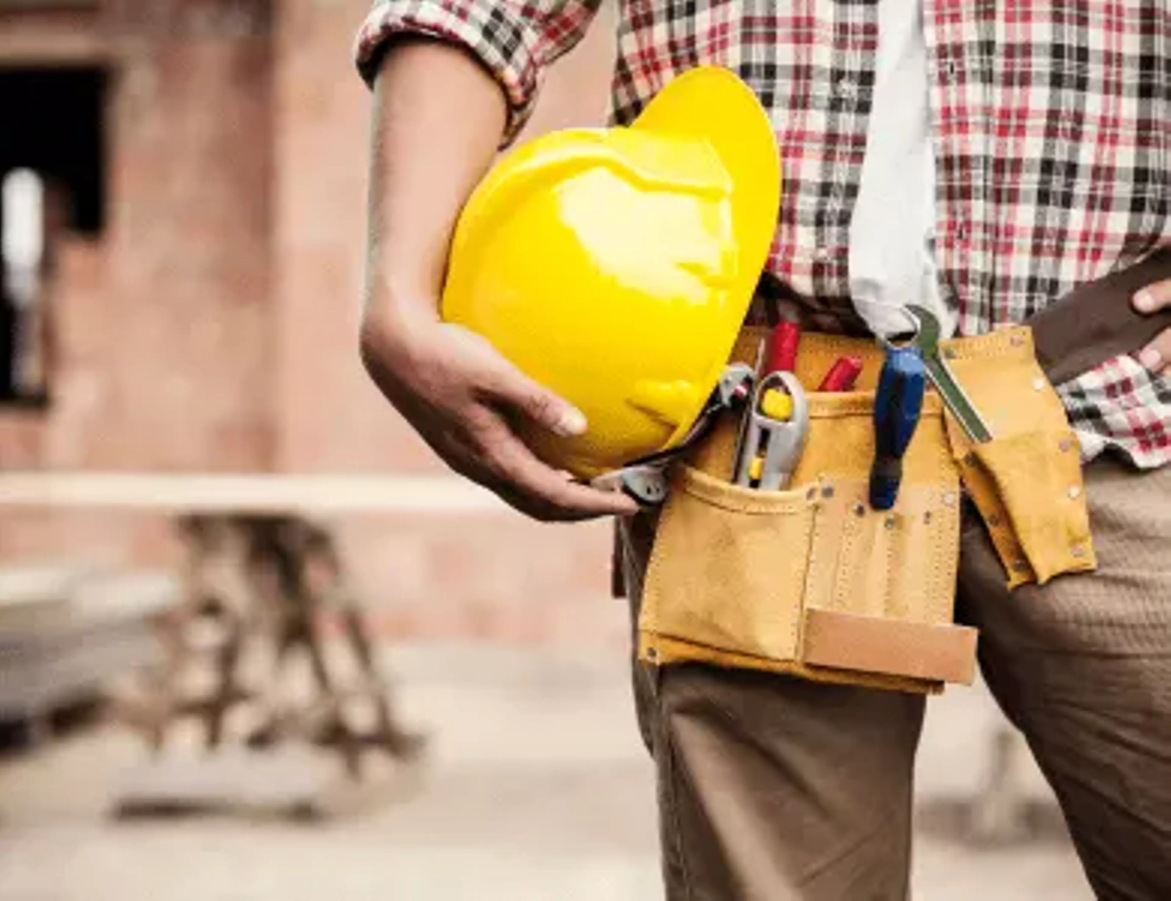 Construction worker holding a hardhat.