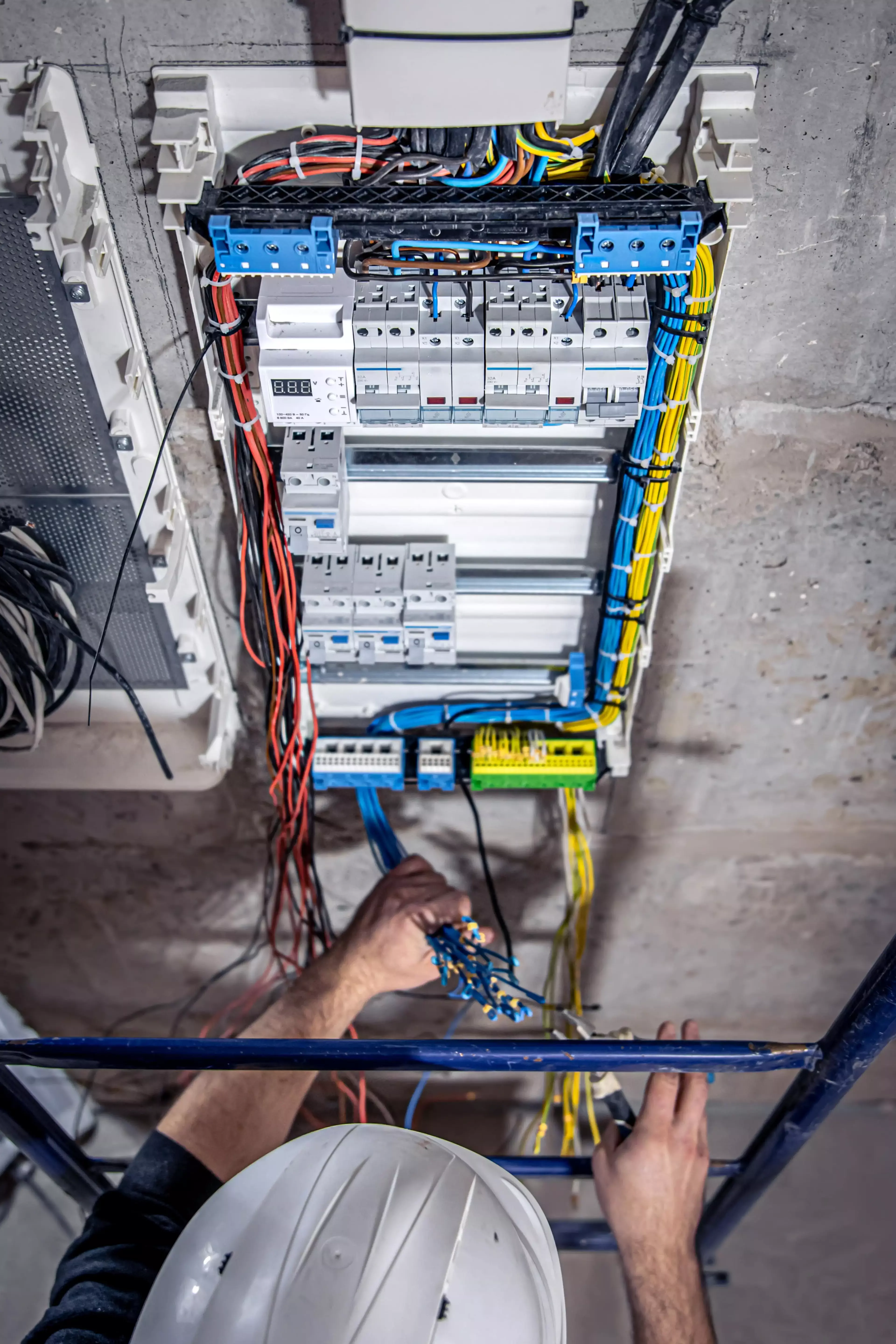 Construction worker working on electrical wirebox.