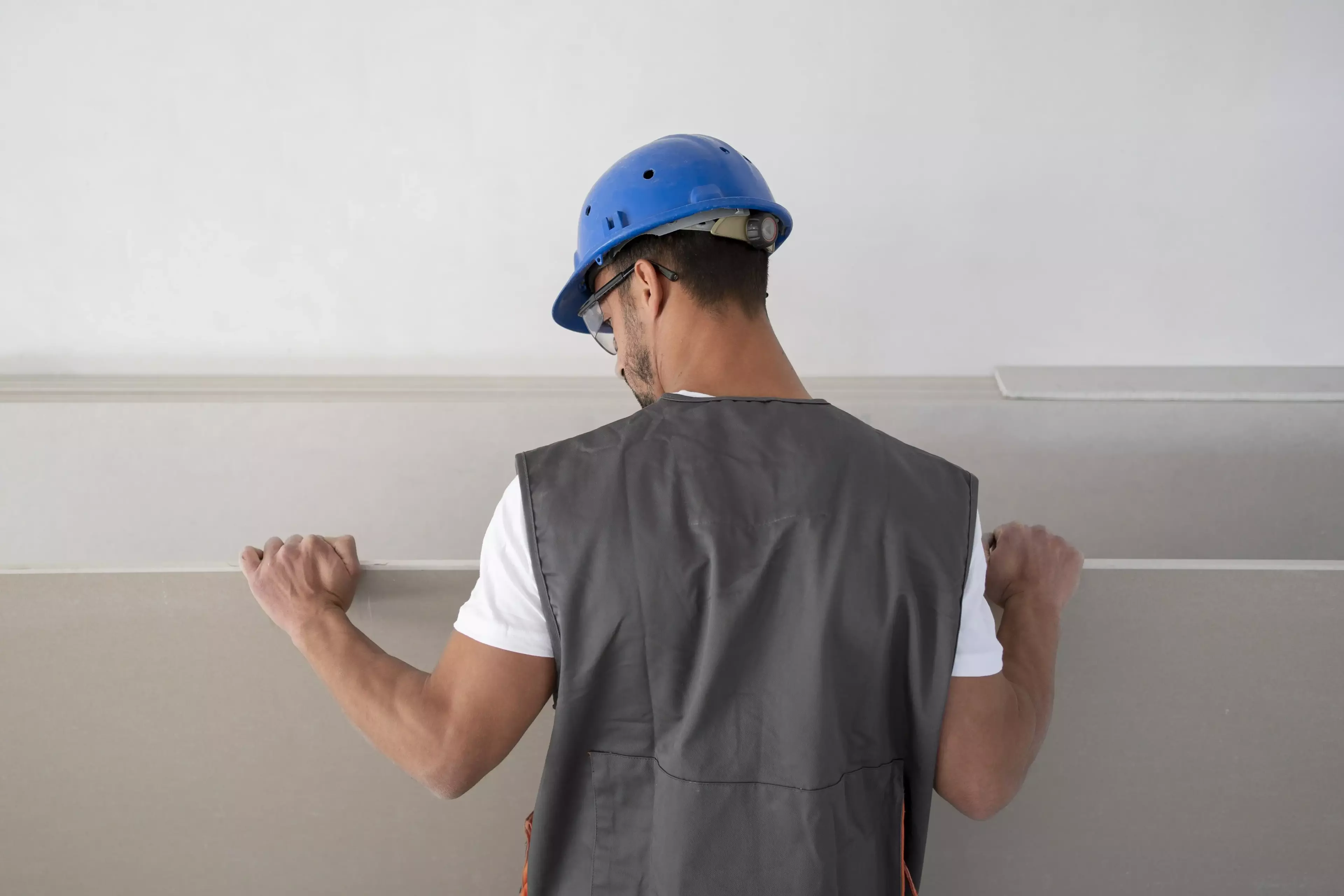 Man holding drywall.