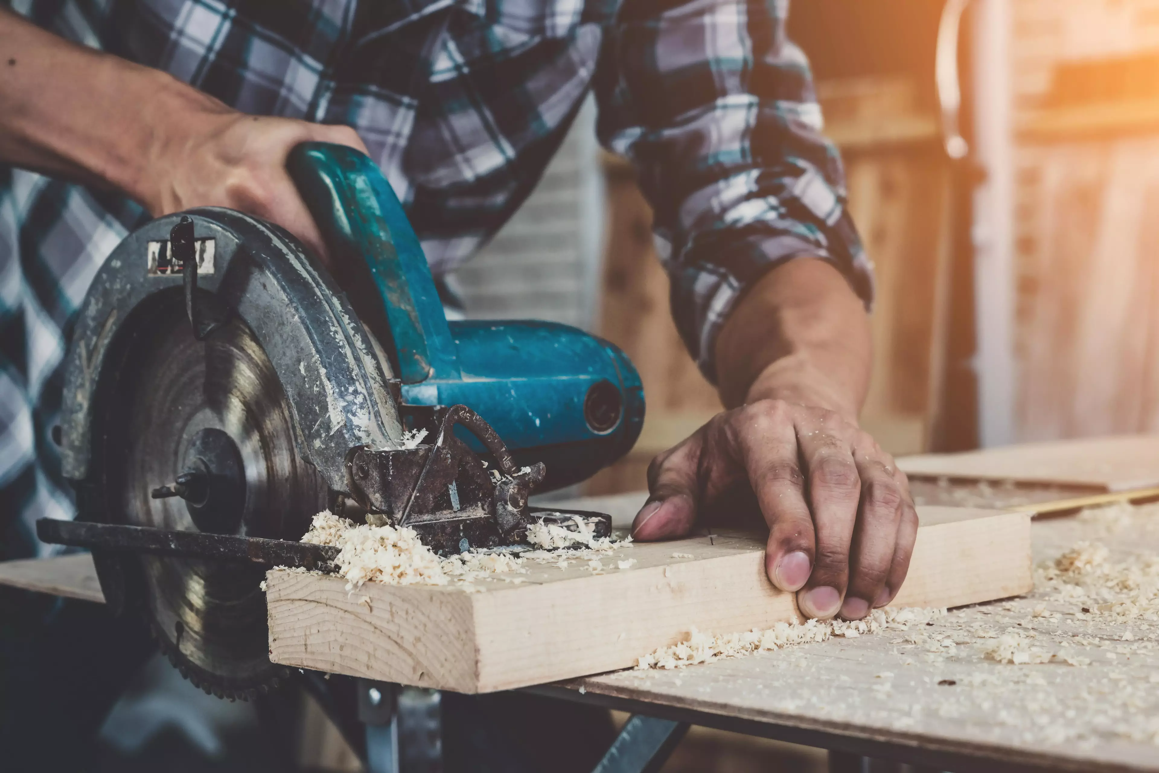 Person with a saw on wood.