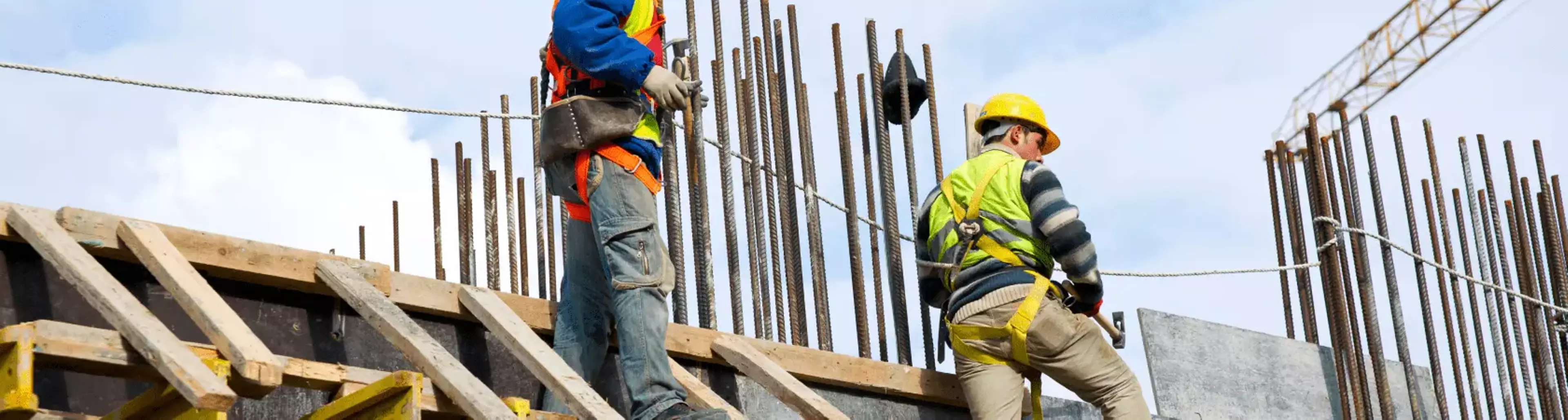 Construction workers examining work at the job site.